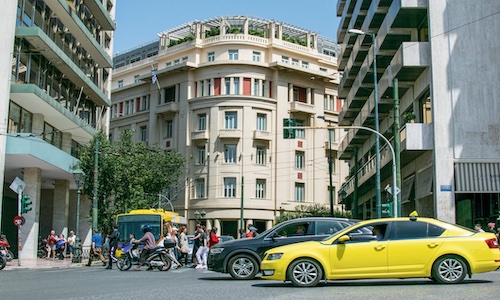 People crossing by a street near Syntagma square of Athens.